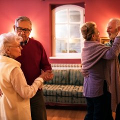 Two senior couple dancing and enjoy together at home